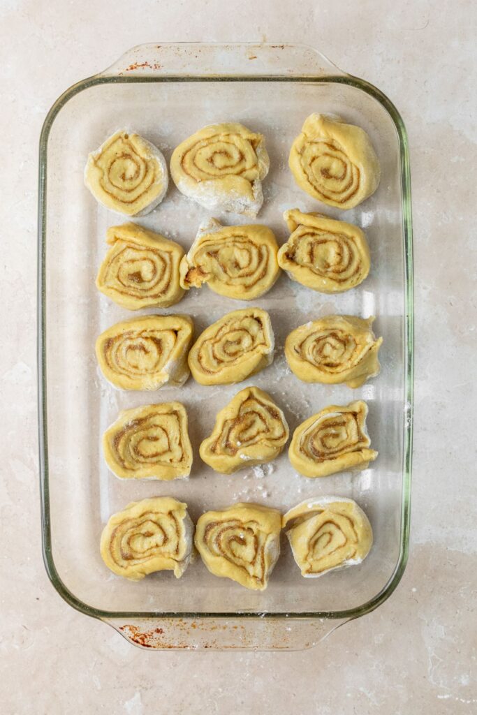 15 cinnamon rolls in a baking pan.