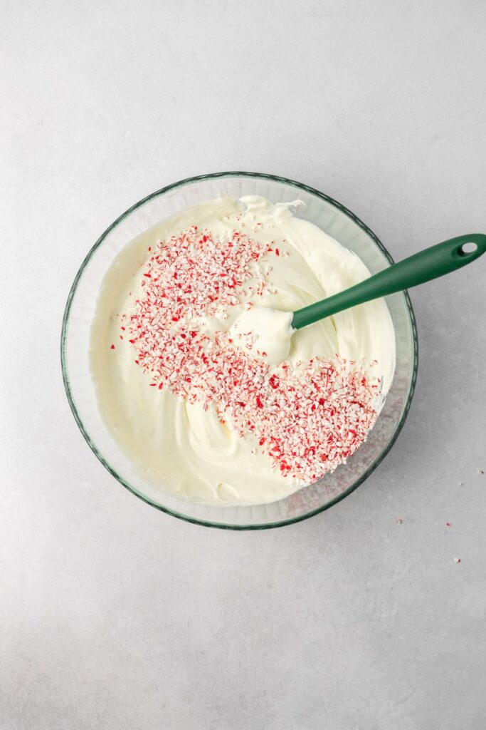 Peppermint ice cream base with crushed candy canes on top.