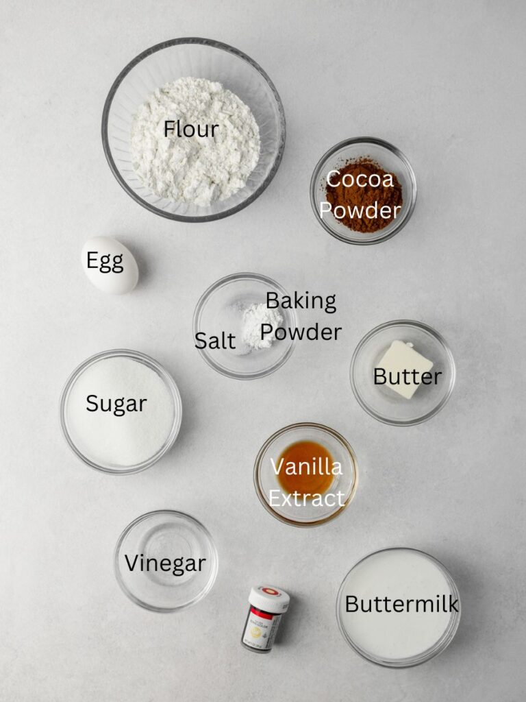 Ingredients needed: flour, cocoa powder, egg, baking powder, salt, butter, sugar, vanilla, vinegar, food coloring, and buttermilk.