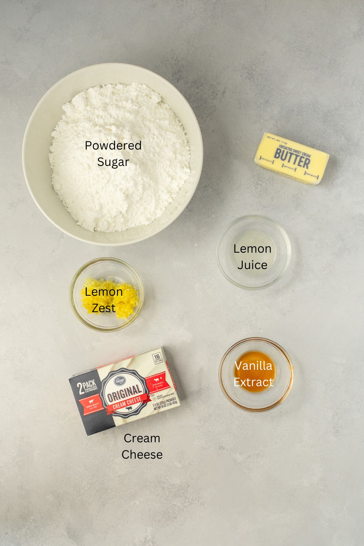 Ingredients laid out: powdered sugar, lemon zest, lemon juice, vanilla, butter, and cream cheese.