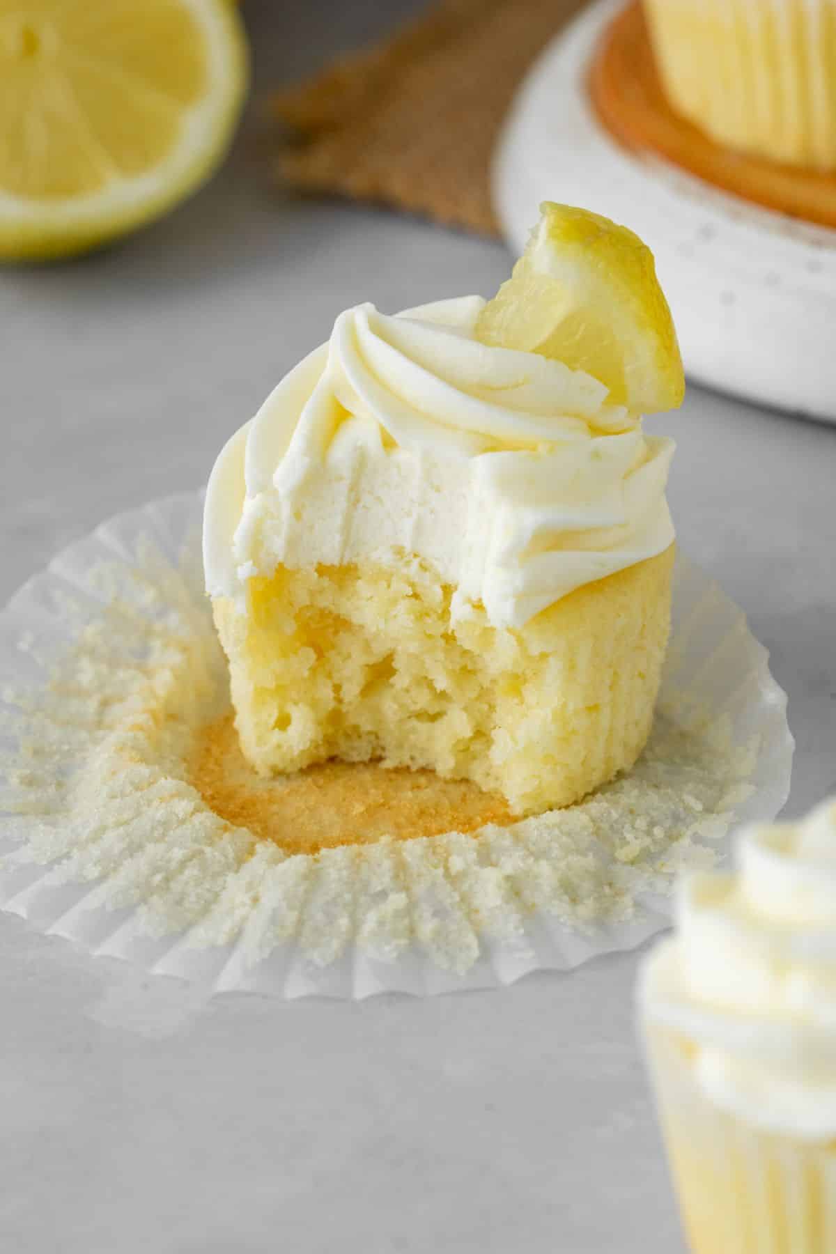 The best moist lemon cupcake with lemon cream cheese frosting and lemon wedge on top.