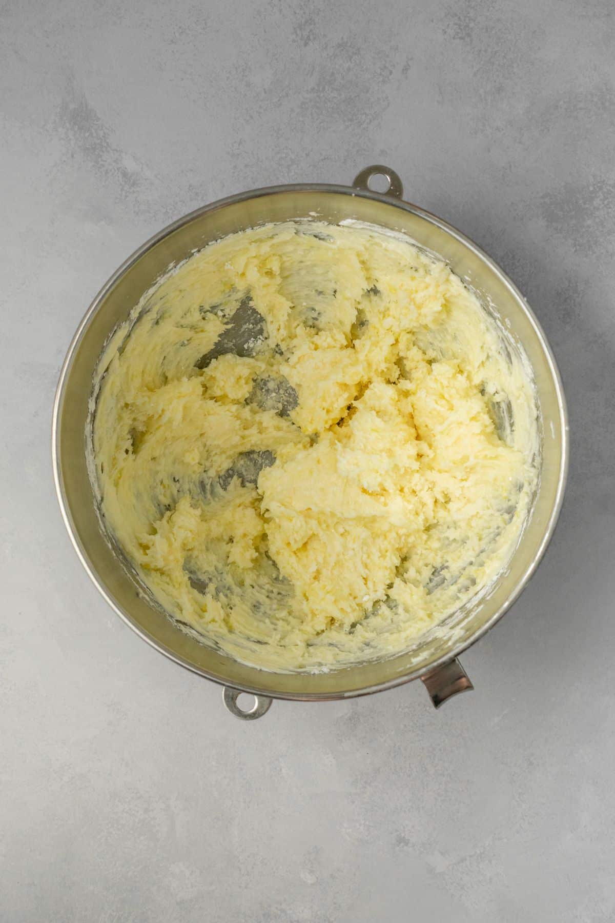 Lemon cream cheese frosting ingredients combined together in a large bowl.