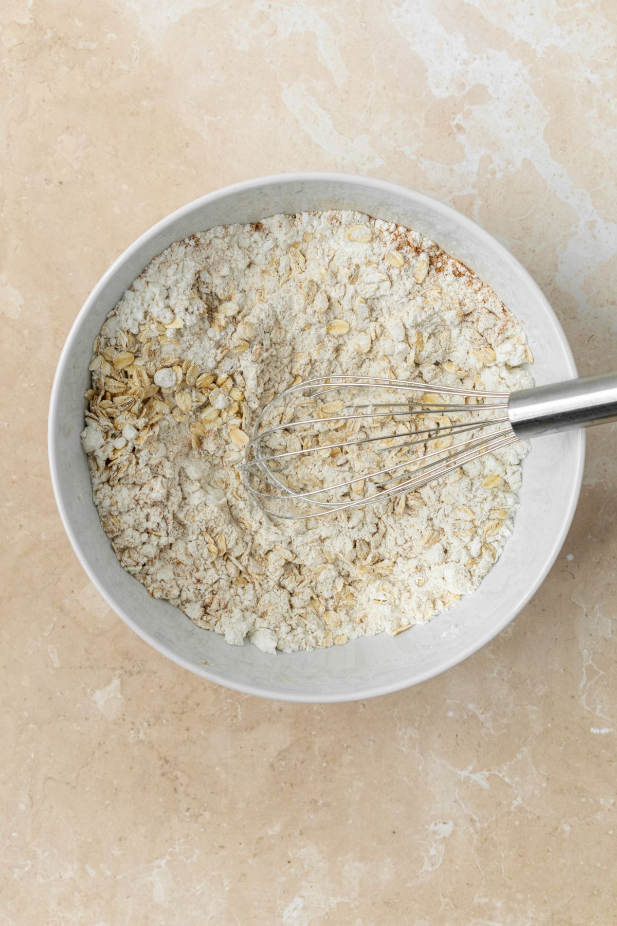 Oats and flour mixed together in a bowl.
