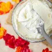 Easy 4 ingredient maple buttercream frosting with a rubber spatula holding some.