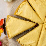 One layer pumpkin cake sliced into eight pieces and topped with pumpkin frosting.
