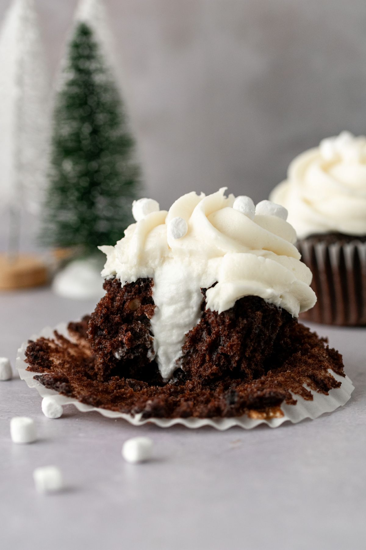Hot chocolate cupcakes with a whipped cream filling and marshmallow buttercream on top.