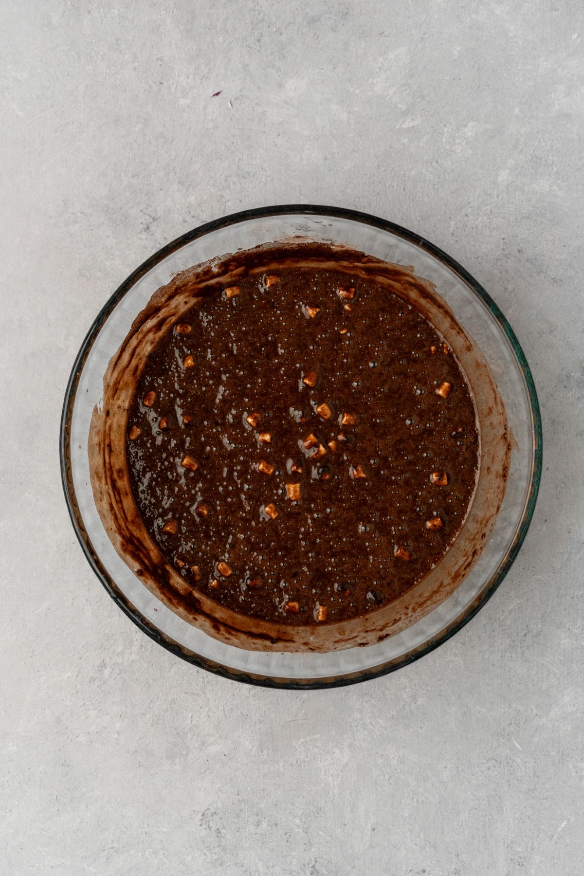 Hot chocolate cupcake batter in a glass bowl.