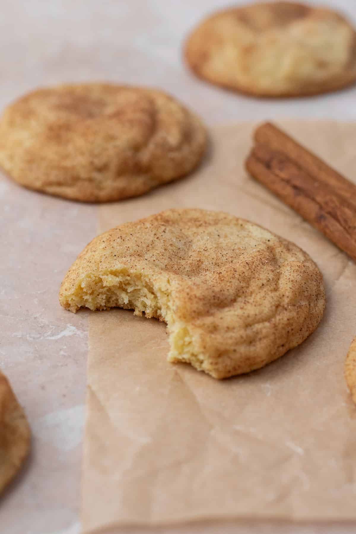 A bite taken out of a soft and chewy snickerdoodle cookie.