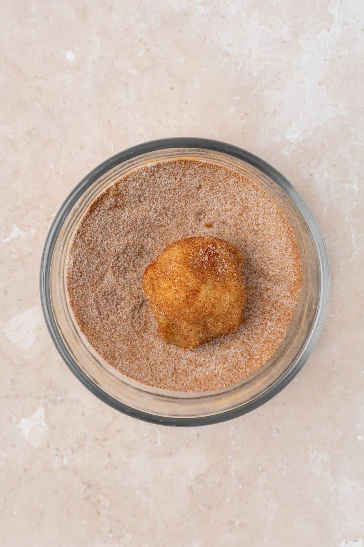 Cookie dough ball rolled in cinnamon sugar.