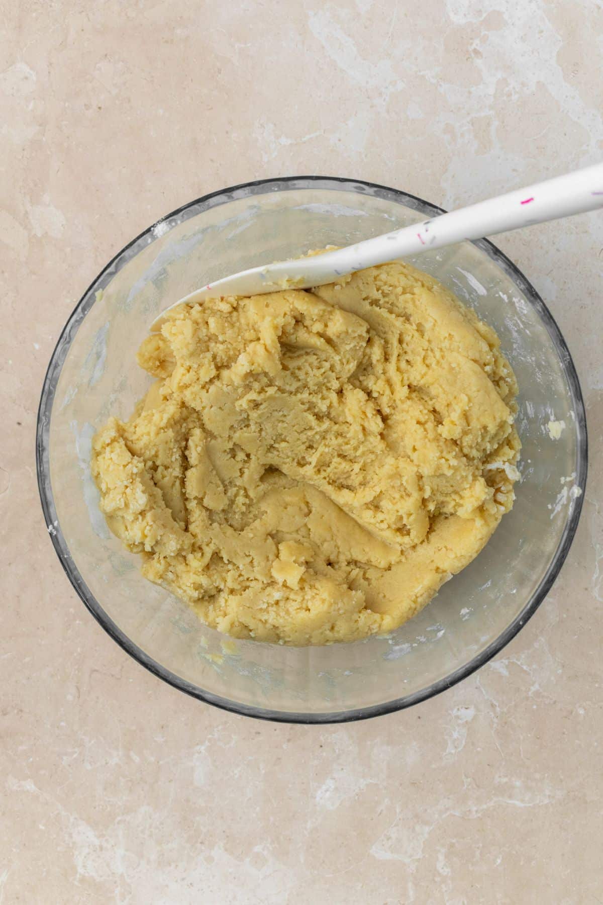 Snickerdoodle cookie dough in a large glass bowl.