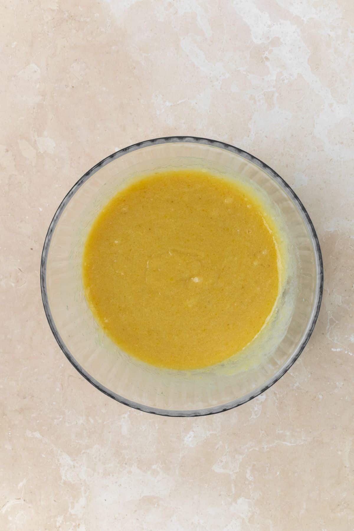 Melted butter, eggs, and sugars whisked together in a large bowl.