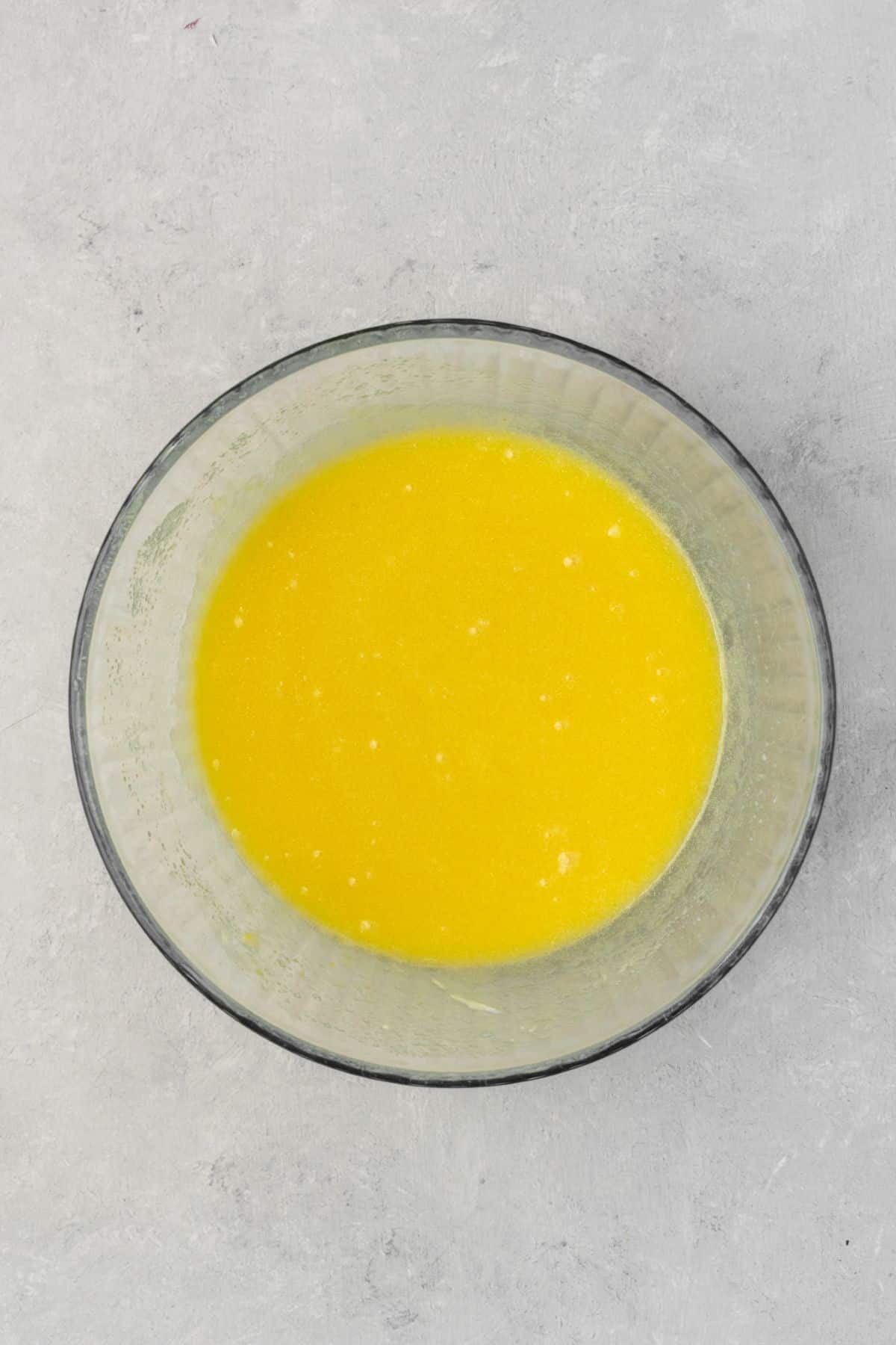 Melted butter, eggs, and sugar whisked together in a large bowl.