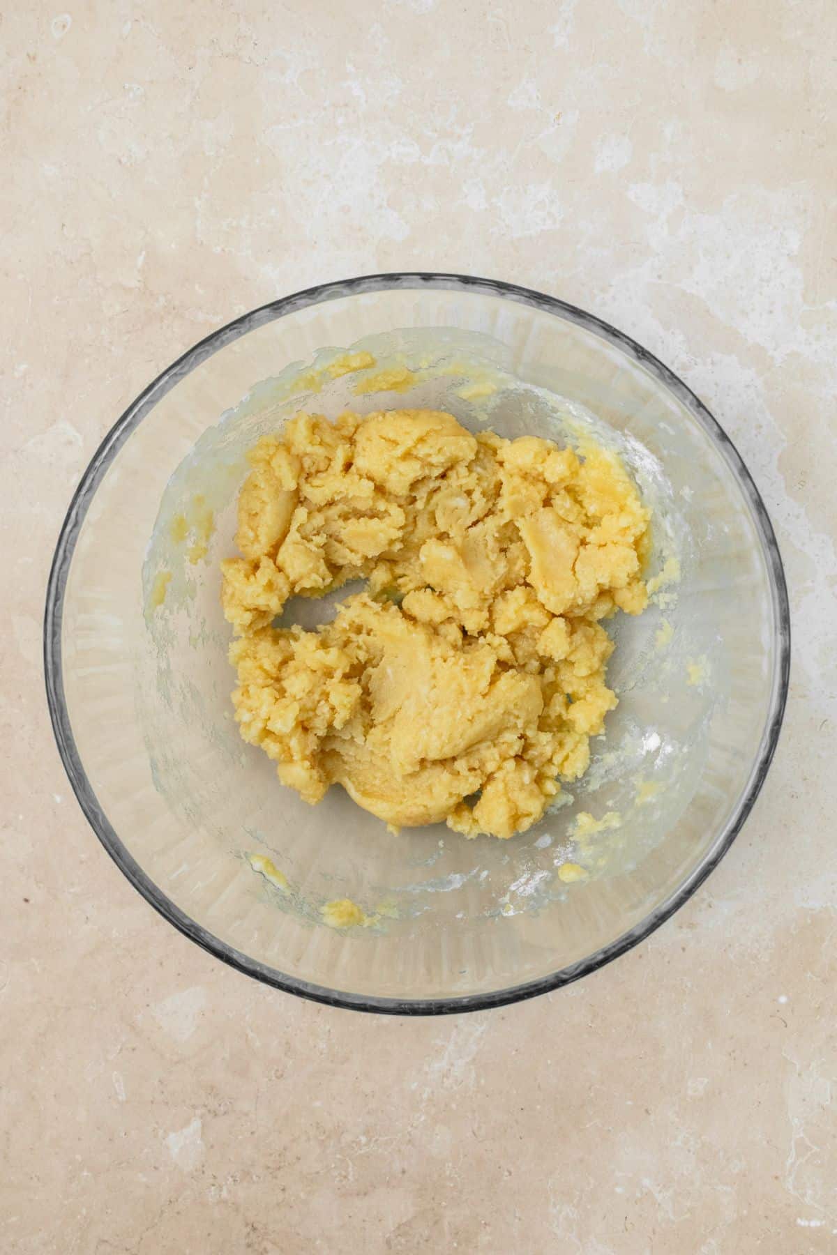 Shortbread crust mixed together in a bowl until the dough forms.