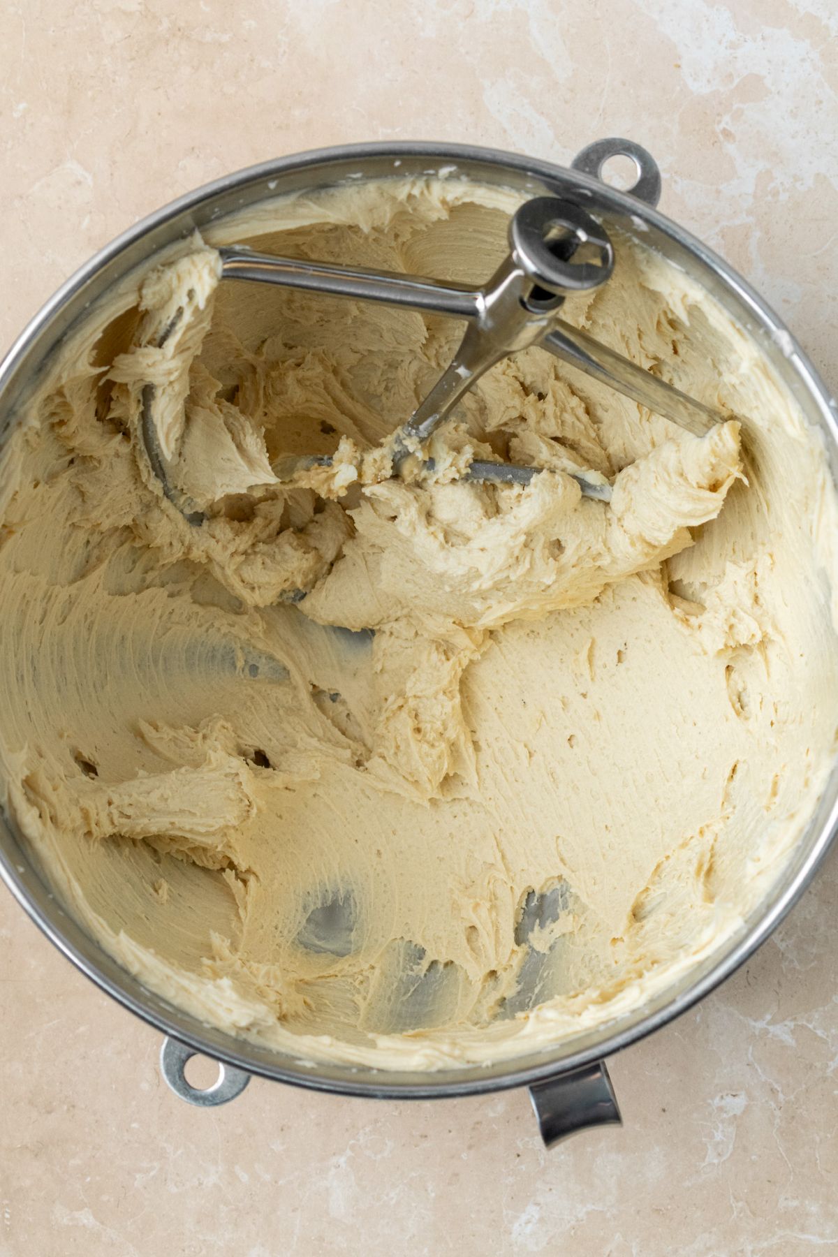 Brown sugar buttercream frosting in a stainless steel stand mixer bowl.