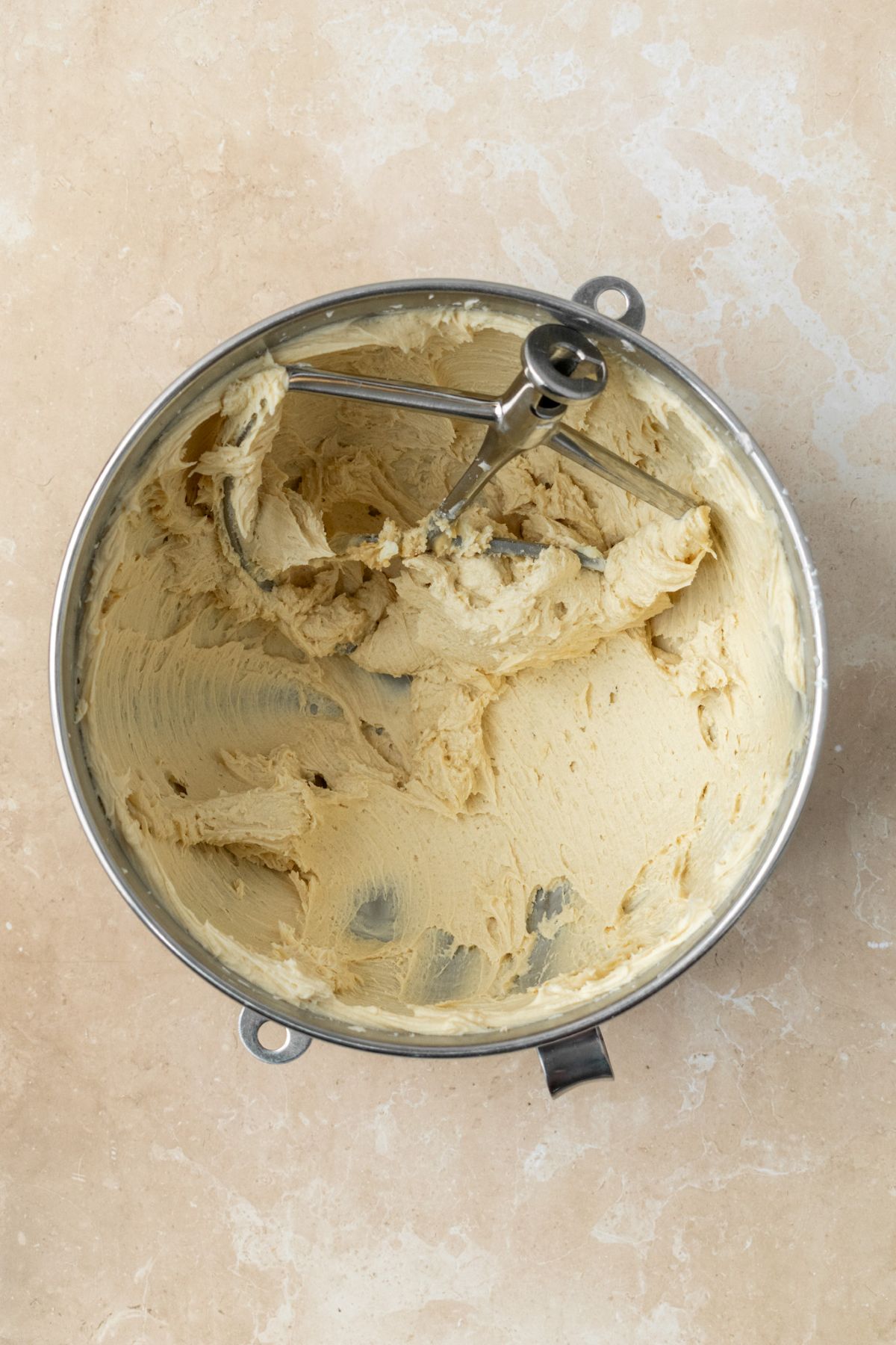 Creamy brown sugar frosting in a stainless steel bowl.