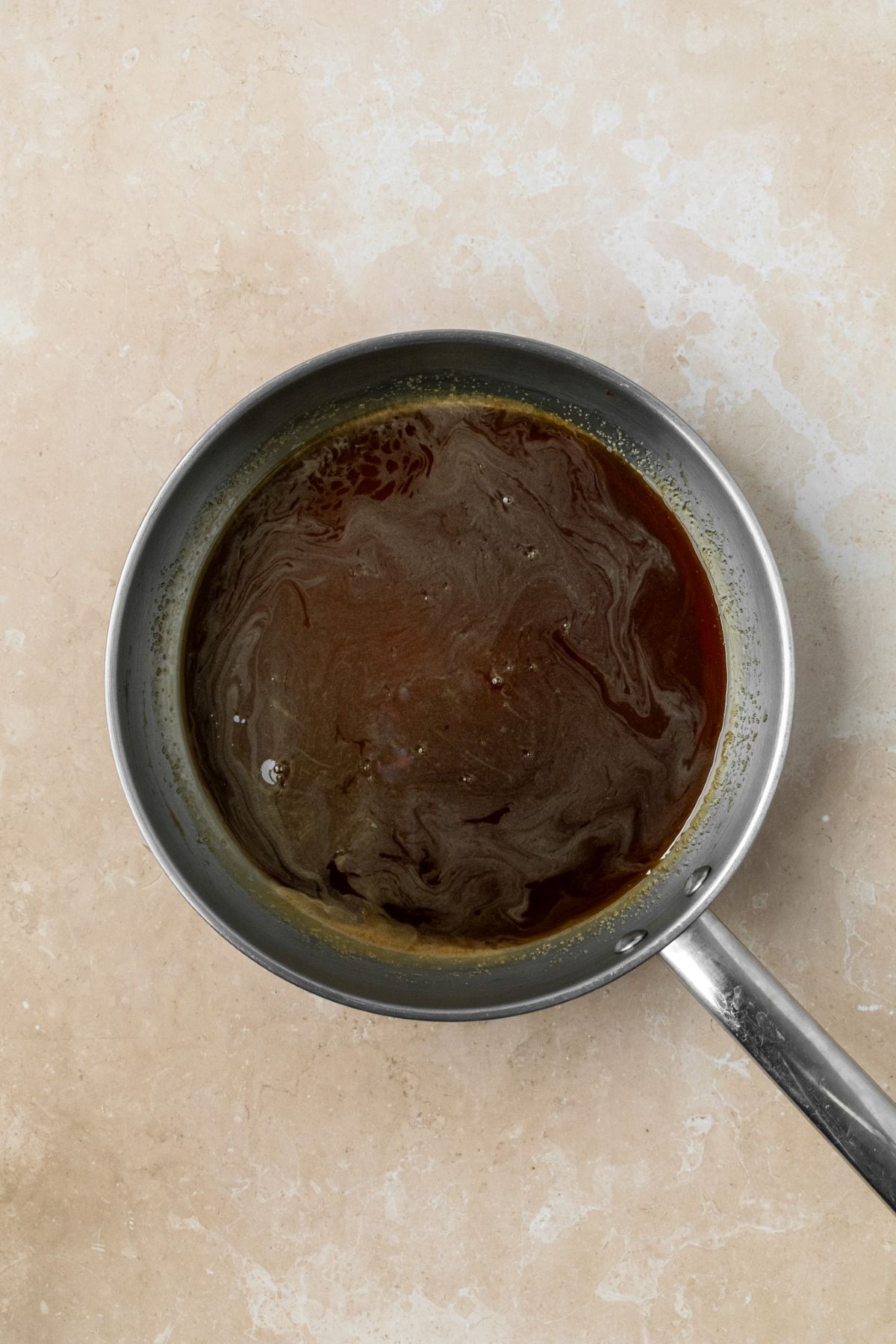 Brown sugar and water cooked together until sugar has melted in a saucepan.