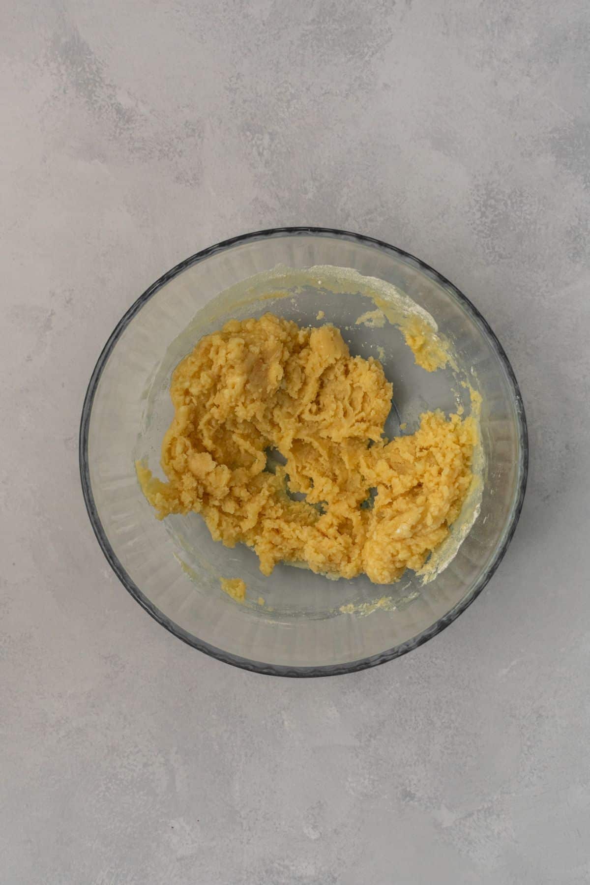 Ingredients for shortbread crust mixed together in a large bowl.