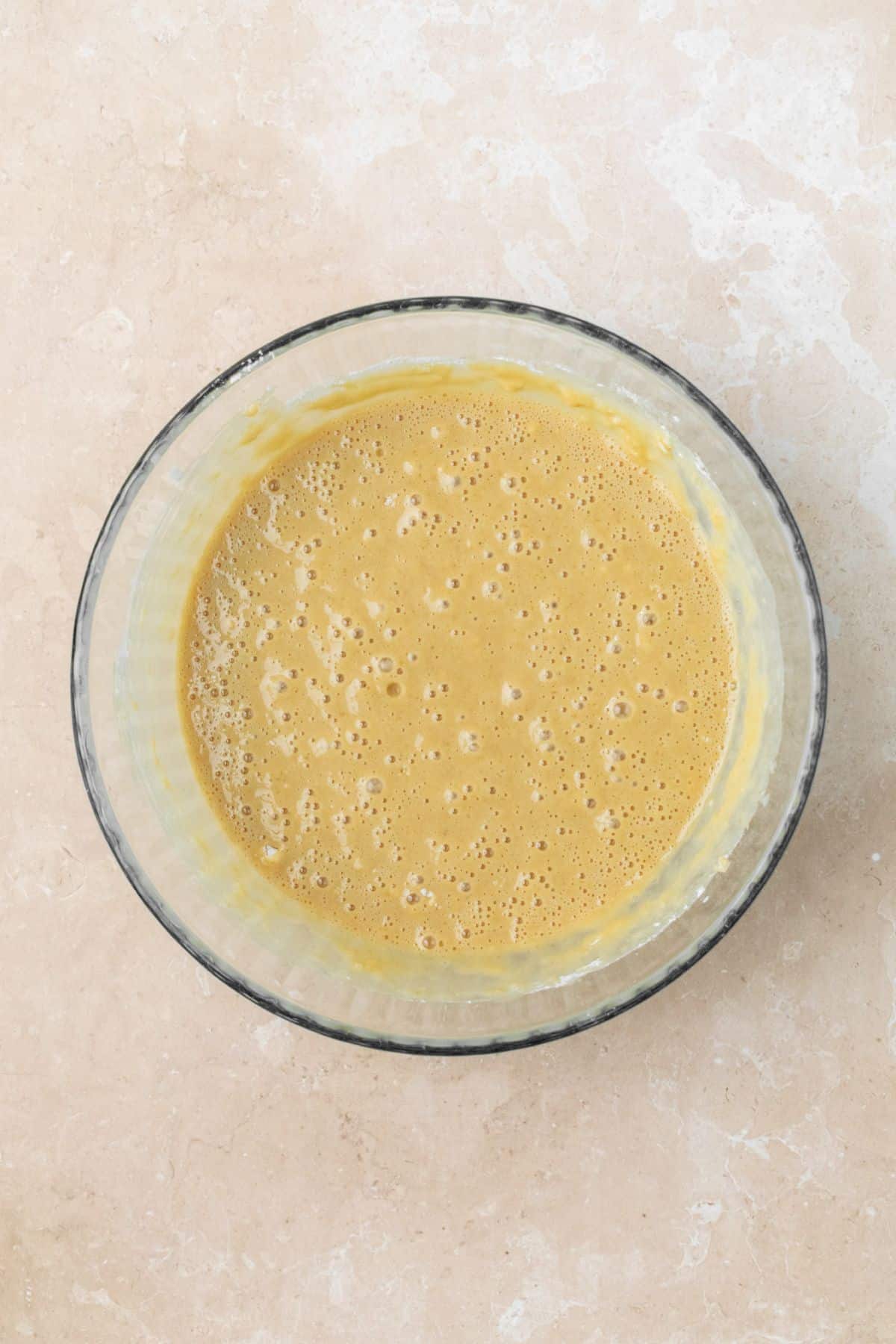 Maple cake batter in a large glass bowl.