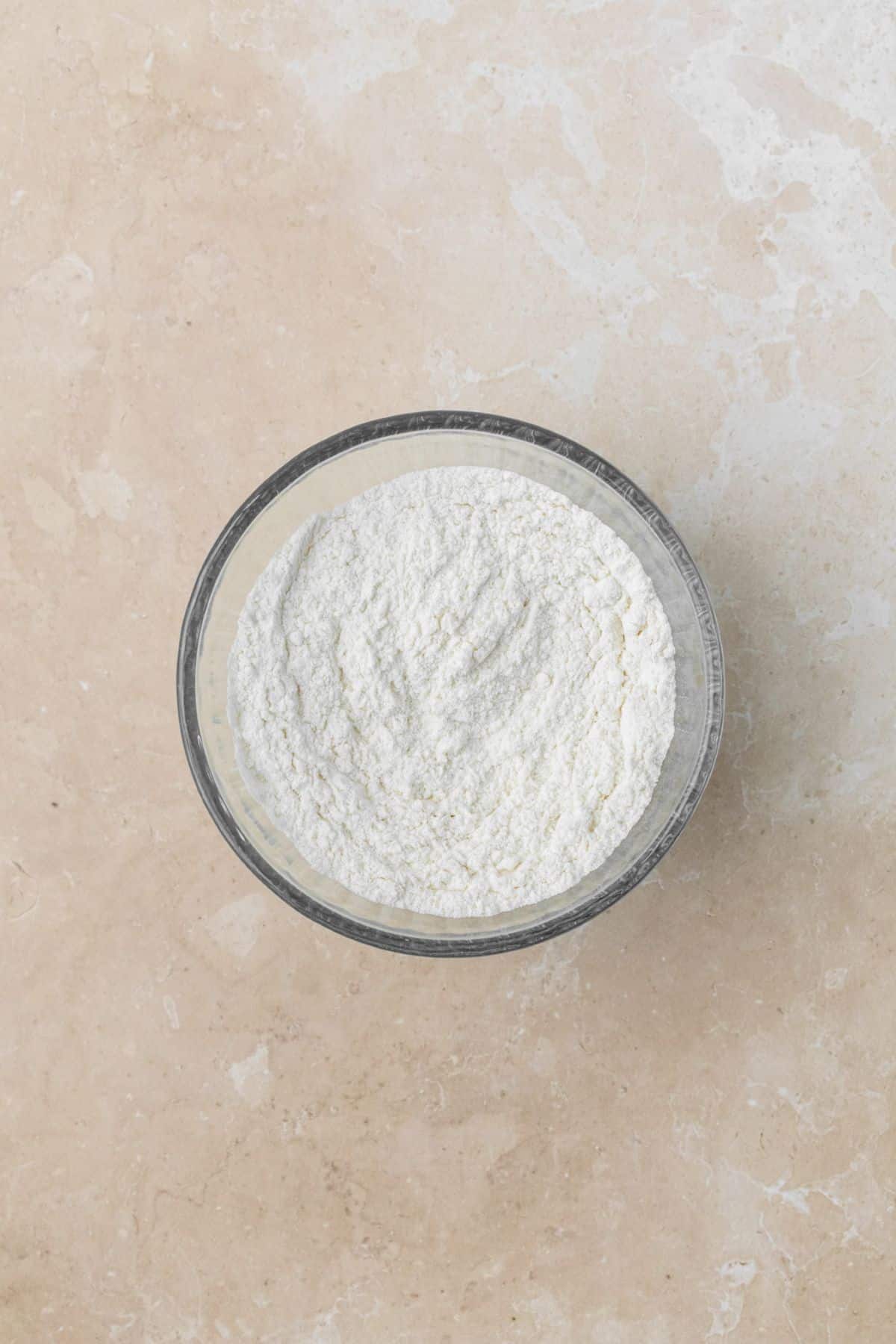 Dry ingredients whisked in a bowl for cupcakes.