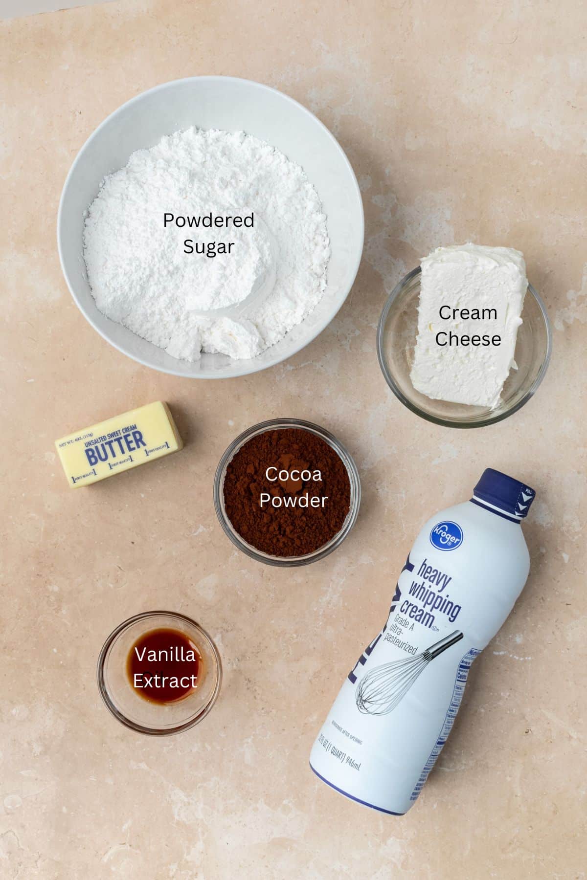 Ingredients for chocolate cream cheese frosting: cocoa powder, heavy whipping cream, powdered sugar, butter, cream cheese, and vanilla.