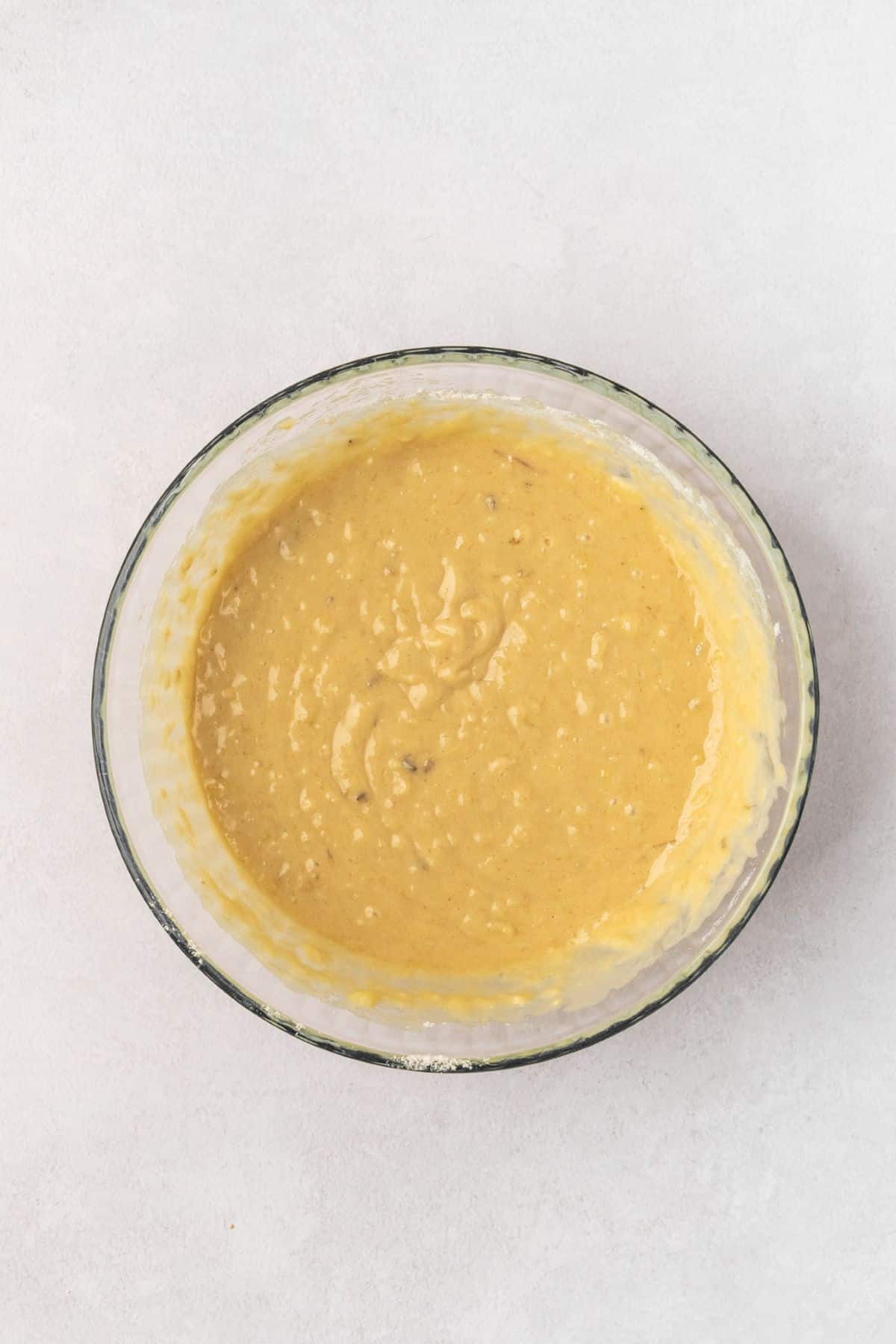 Banana cake batter in a large bowl.