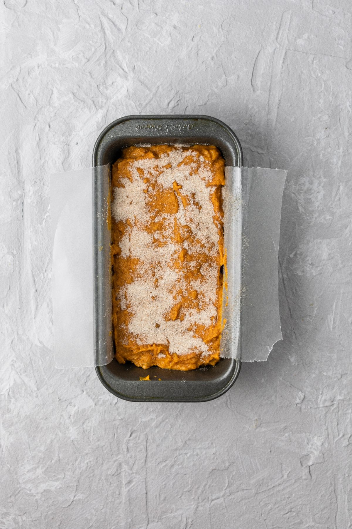 Pumpkin spice banana bread batter in a loaf pan ready to bake.