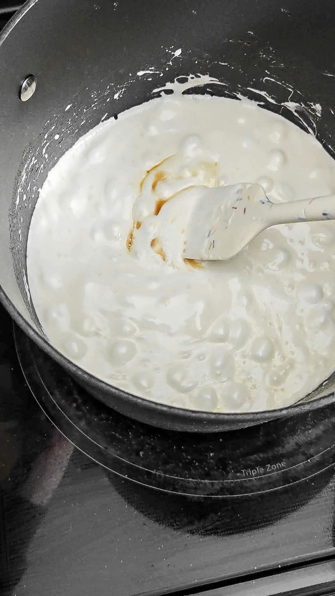 Melted marshmallows in a pot with maple syrup mixed into it.