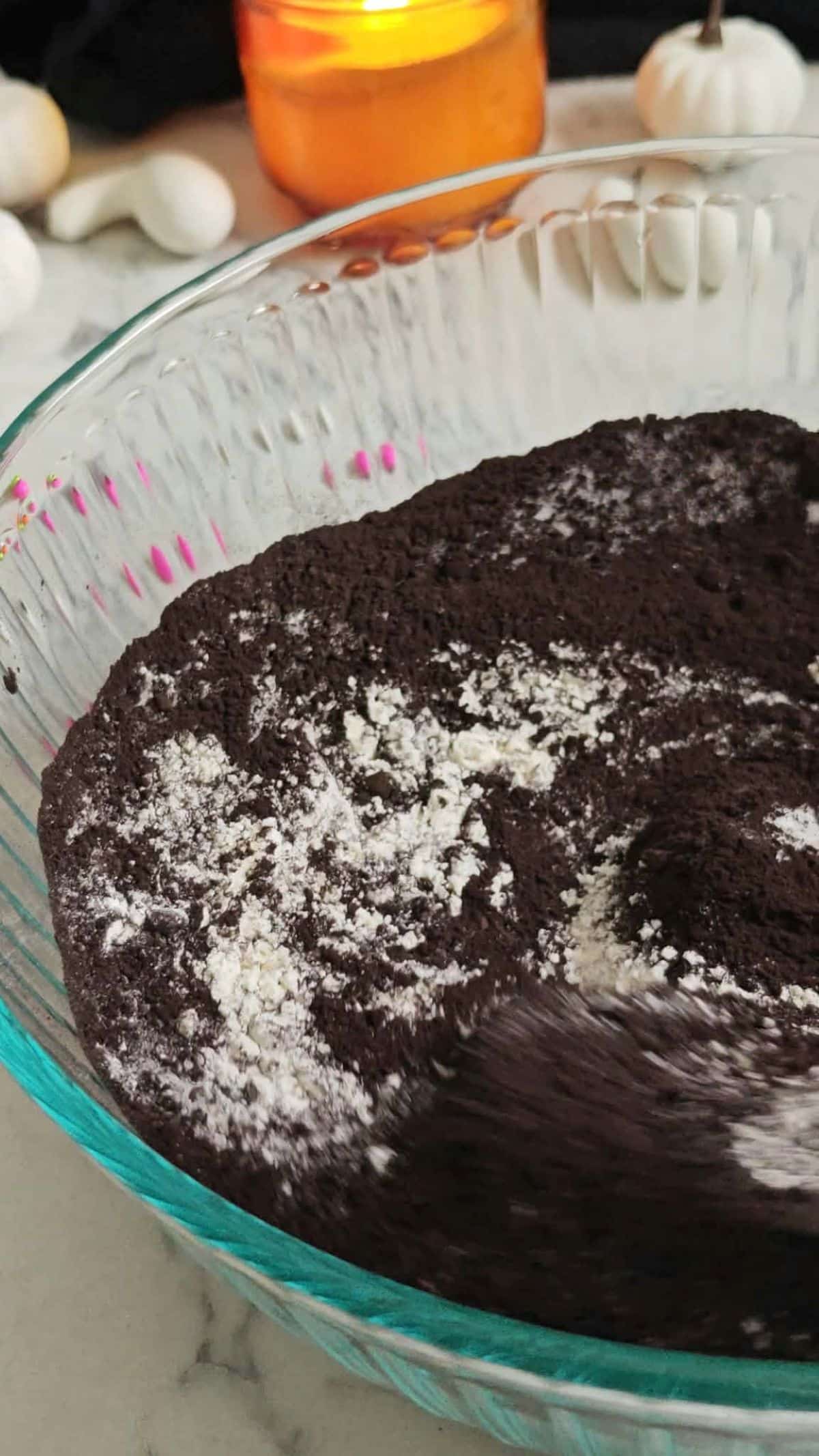 Dry ingredients whisked together in a glass bowl for cake.